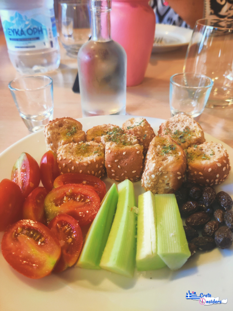 A traditional Cretan treat (meze), containing tomatoes, cucumbers, rusks and olives.